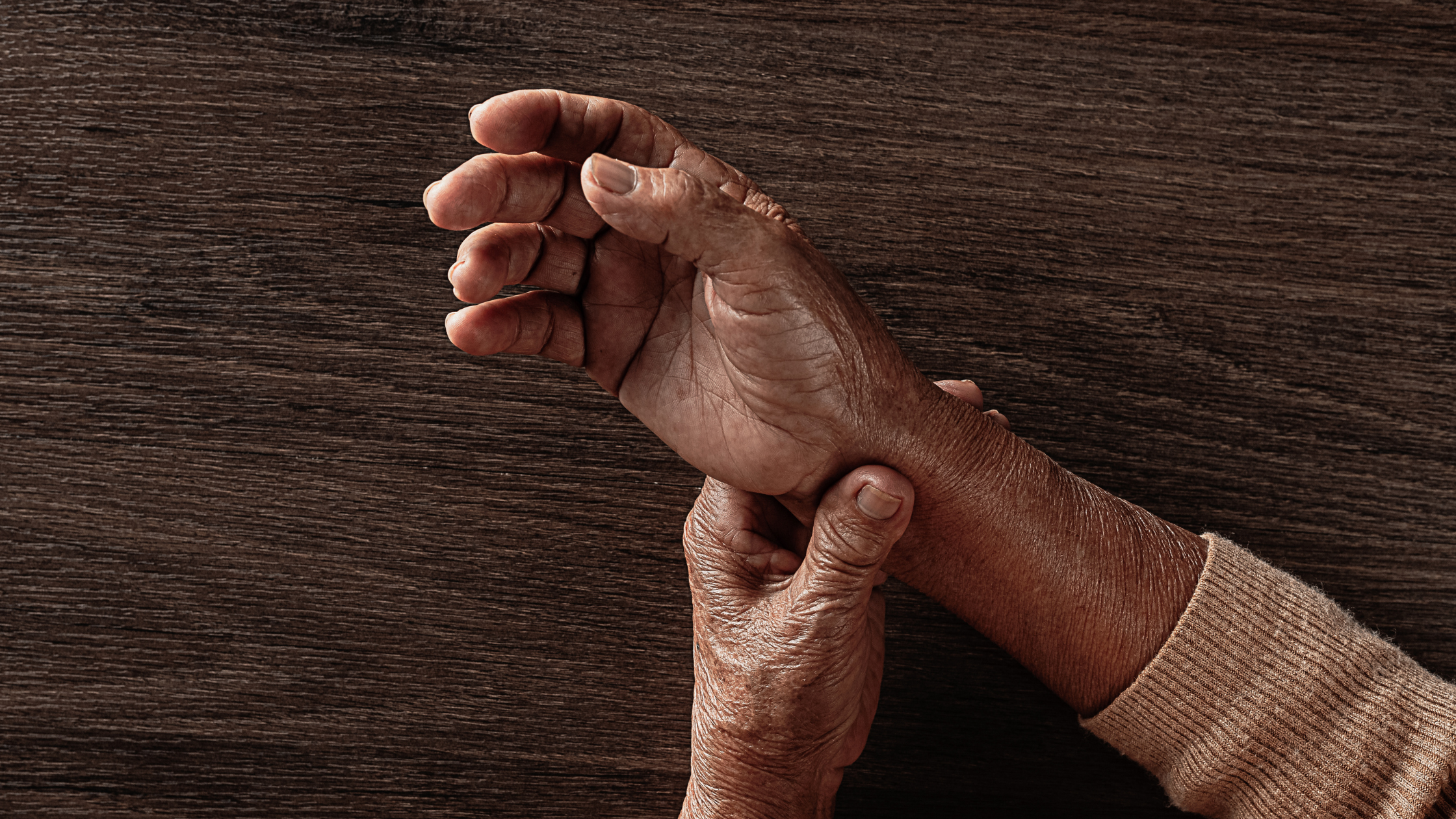 Close-up of hands affected by arthritis, showing joint stiffness and pain, representing conditions evaluated under a VA disability arthritis rating.