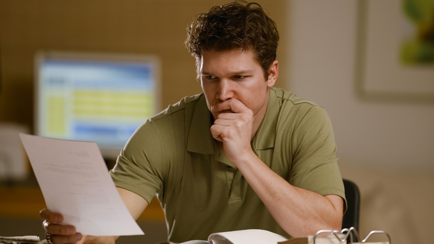 Veteran reviewing paperwork at desk, representing VA Form 21-4138 and the process of submitting a statement in support of a VA claim.